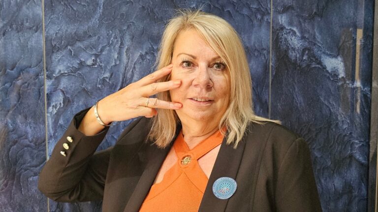 Face of TN campaign supporter showing three fingers